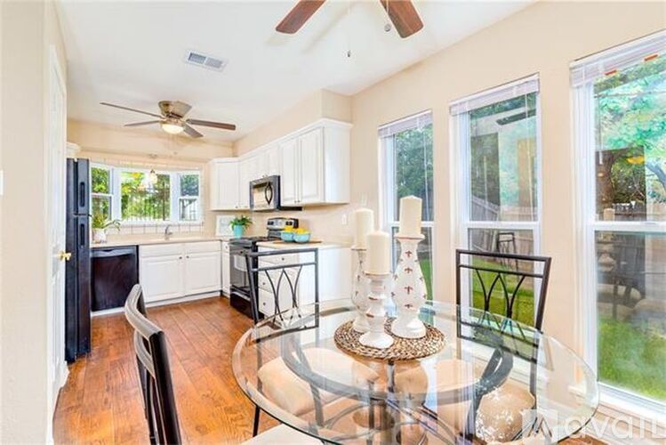 A kitchen with a glass table and chairs.