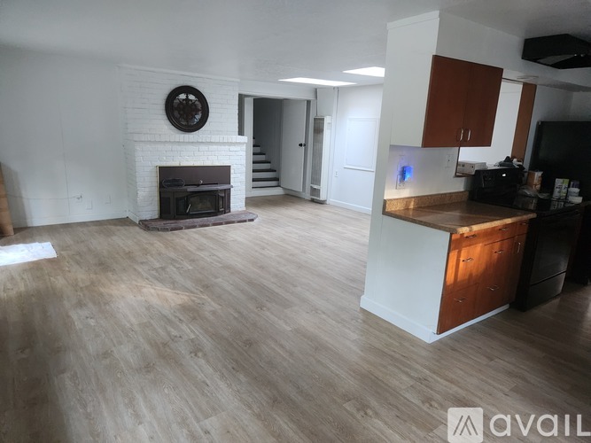 A spacious living room with a fireplace and a television.