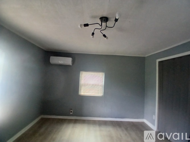A room with a ceiling fan and a window.