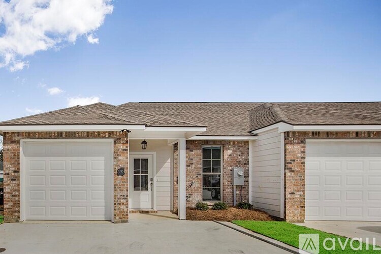 A house with a white garage door is for sale.
