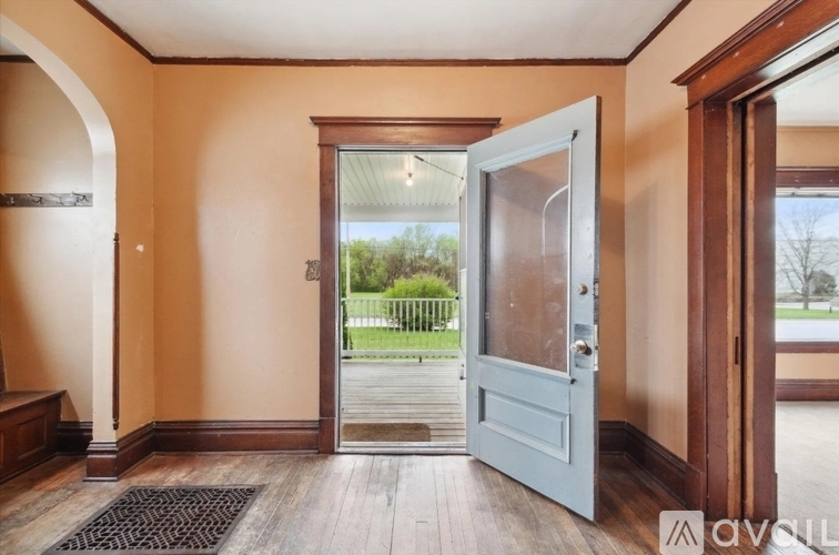 A white door is open to a balcony.