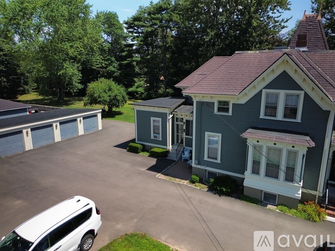 A house with a car parked in front.