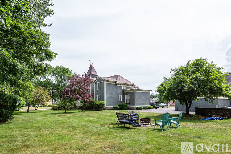 A house with a lawn and trees in front of it.