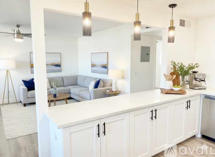 A modern kitchen with white cabinets and a large island.