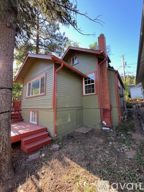 A house with a red staircase and a red door.