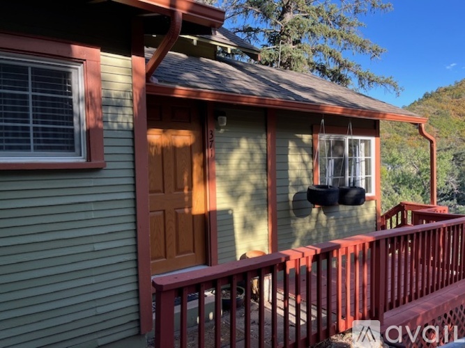 A house with a red fence and a brown door.