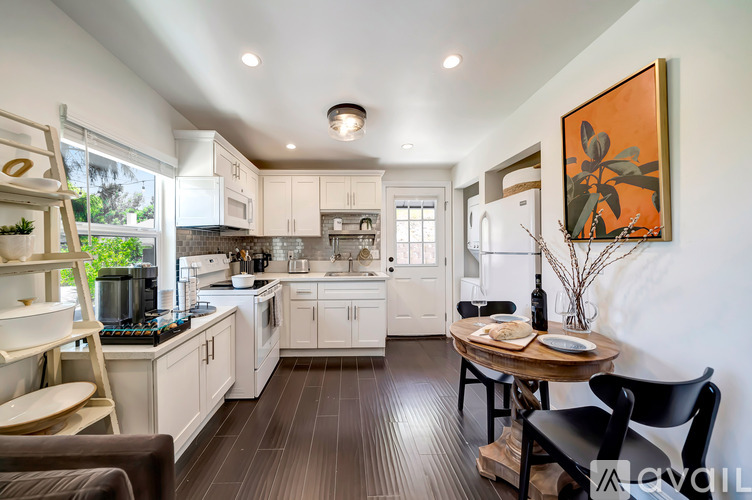 A modern kitchen with a dining table and chairs.