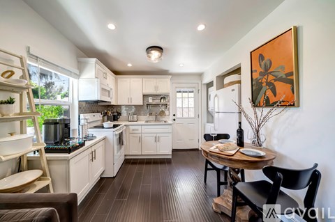 A modern kitchen with a dining table and chairs.
