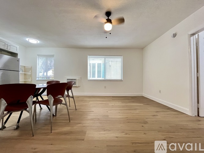 A room with a table and chairs is available for rent.