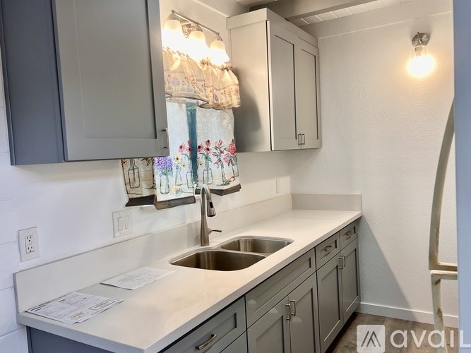 A kitchen with a sink and cabinets.