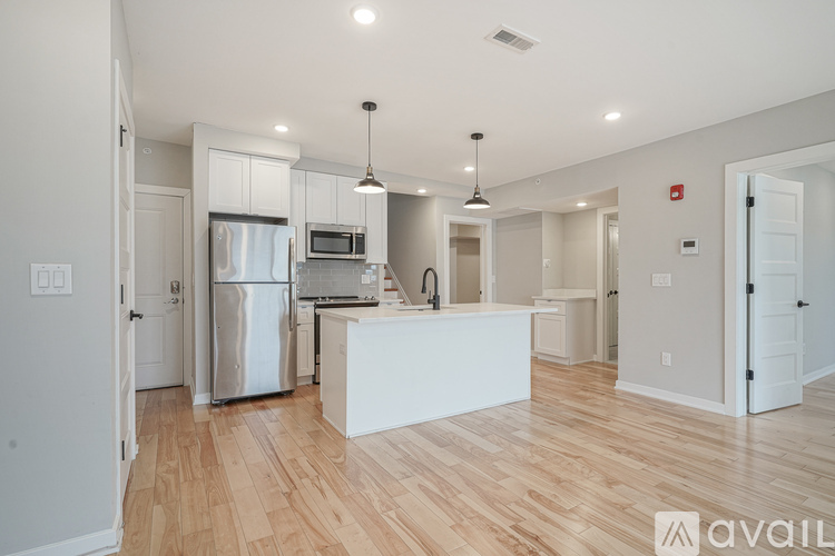 A kitchen with a white island in the middle of the room.