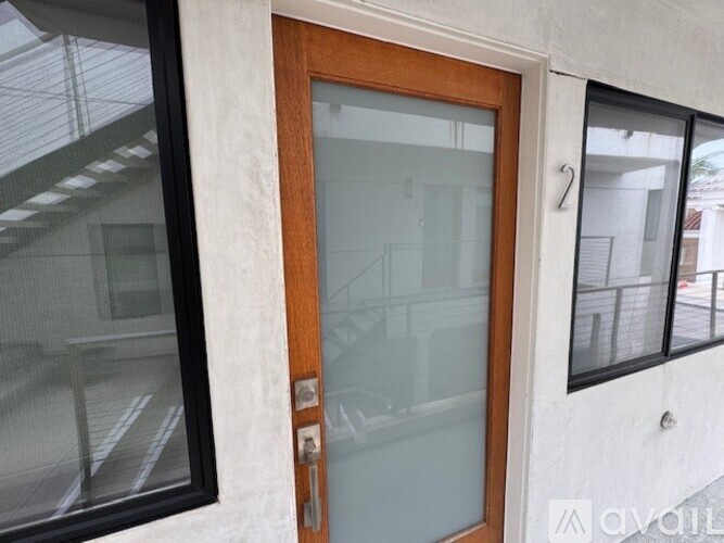 A glass door with a wooden frame is closed.