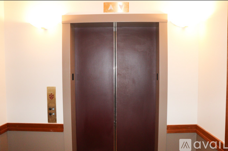 A brown double door with a sign above it.