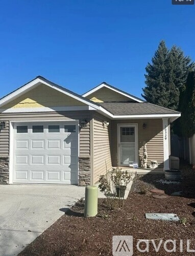 A house with a white garage door and a brown roof.