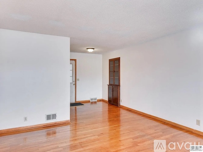 A room with wooden floors and white walls.