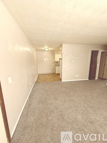 A room with carpeted floor and white walls.