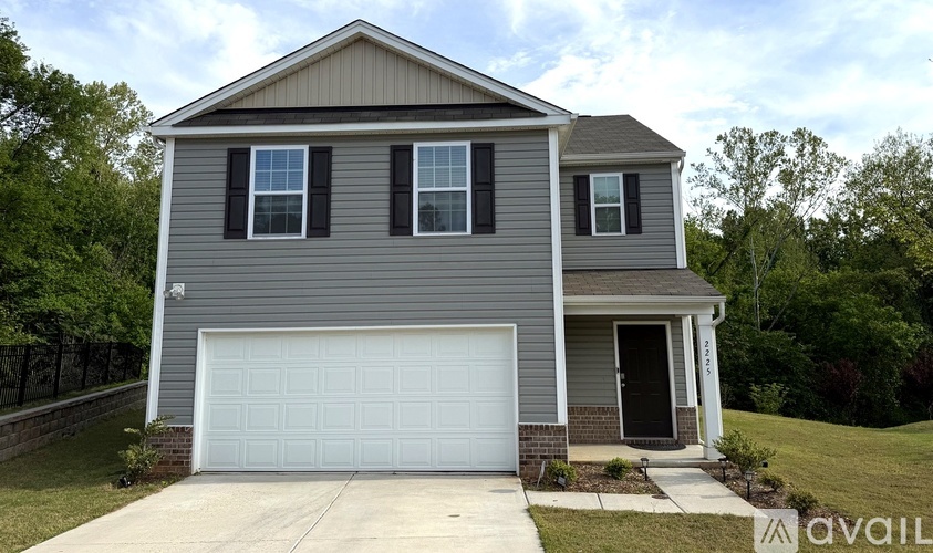 A two-story house with a garage is available for sale.