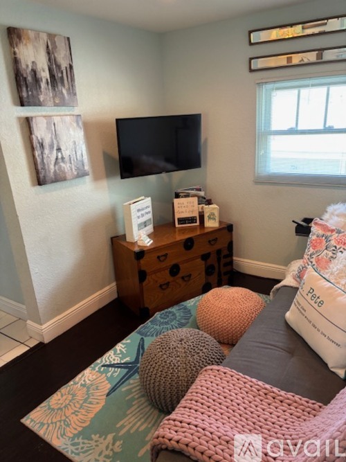 A living room with a couch, a TV, and a dresser.