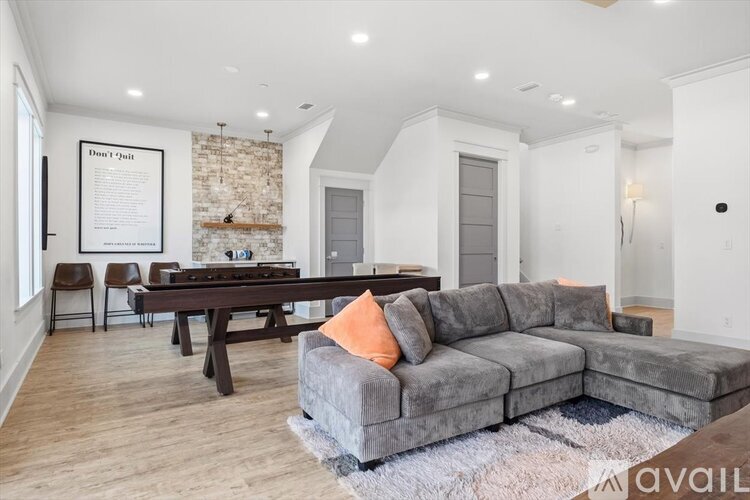 A living room with a grey couch and a wooden table.