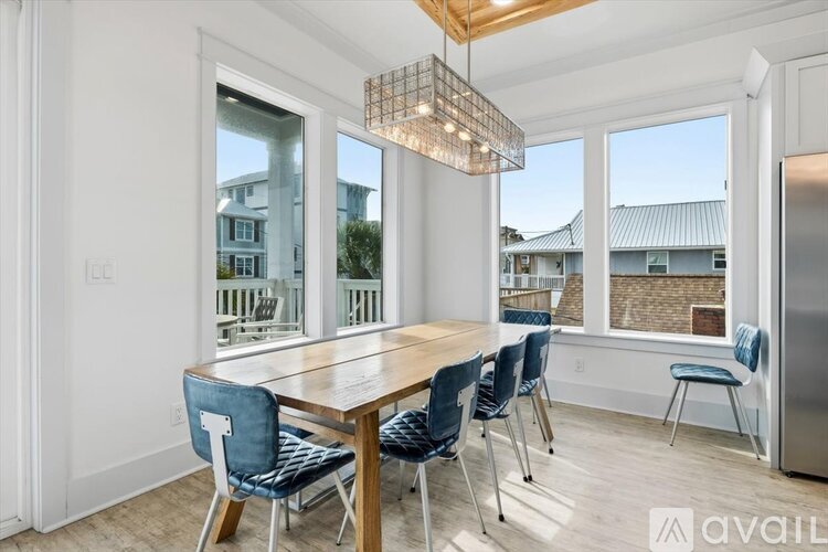 A dining room with a wooden table and blue chairs.