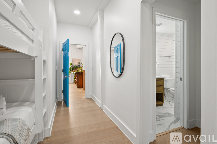 A bedroom with a bunk bed and a mirror on the wall.