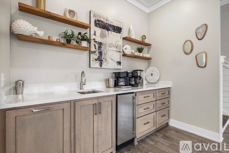 A kitchen with wooden cabinets and a fridge.