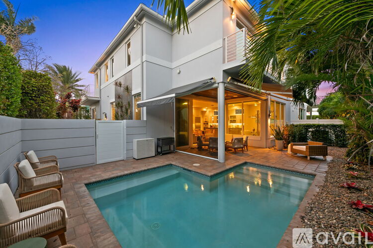 A modern house with a pool in the backyard.
