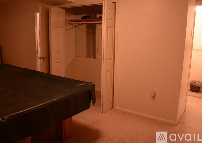 A bedroom with a bed and a closet.