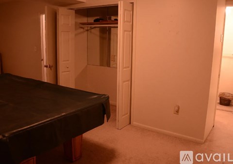 A bedroom with a bed and a closet.