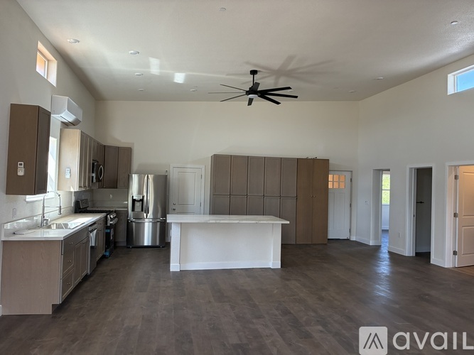 A spacious kitchen with a large island in the middle.