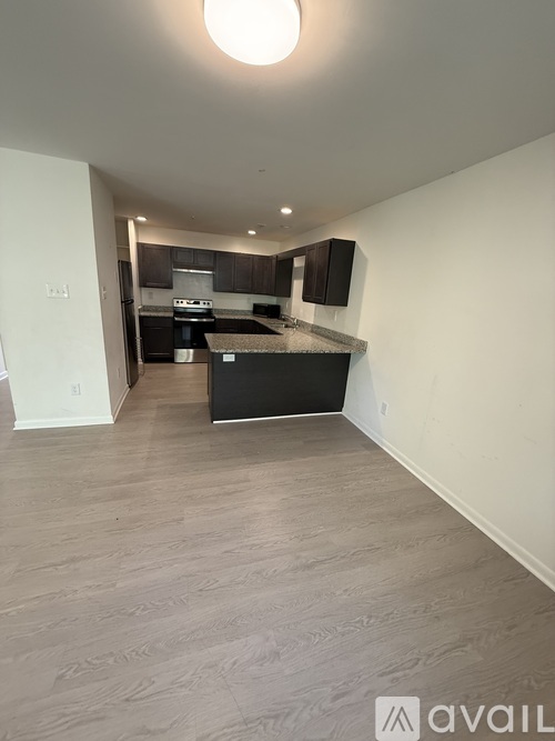 A kitchen area with a black countertop and cabinets.