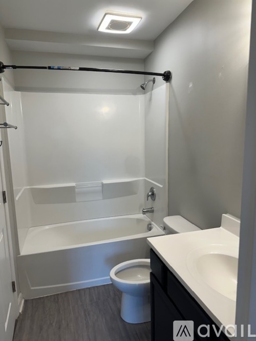 A bathroom with a toilet, sink, and bathtub.