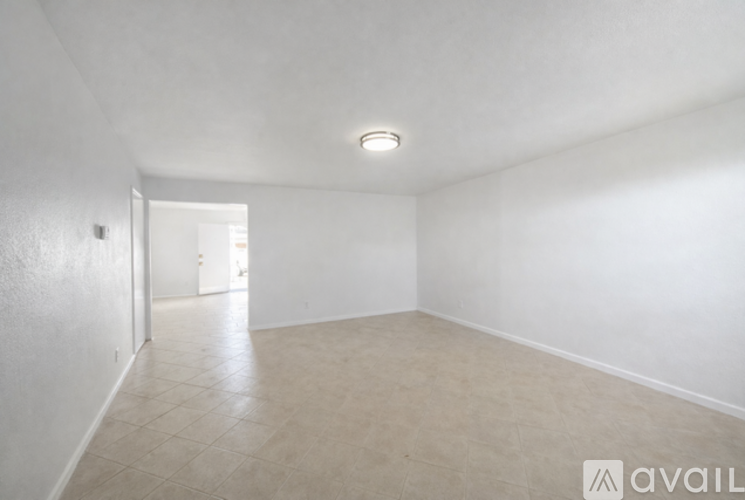 Empty room with tiled floor and white walls.