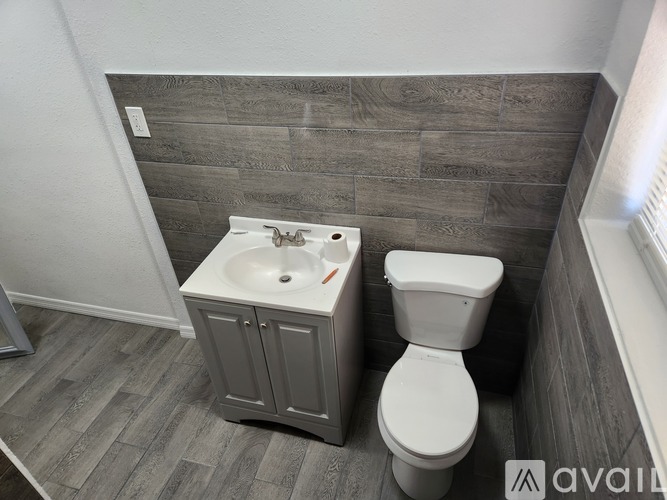 A bathroom with a toilet and sink.