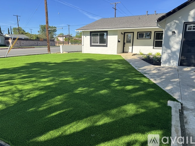 A house with a green lawn in front.