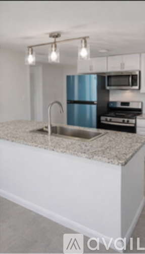 A kitchen with a blue refrigerator and a granite countertop.