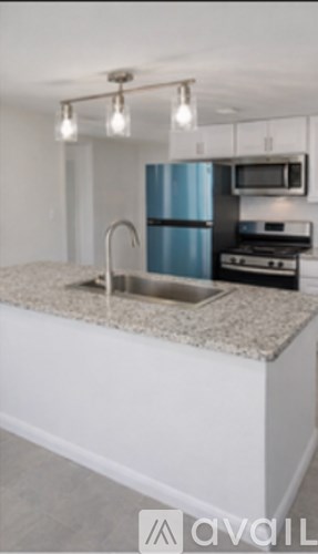 A kitchen with a blue refrigerator and a granite countertop.