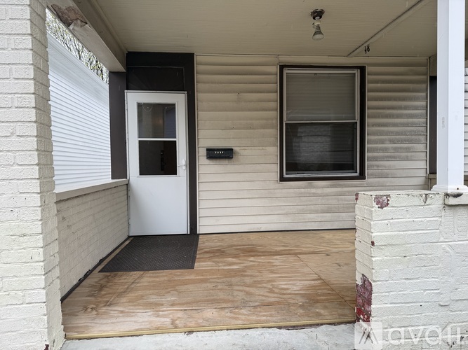 A white door is on the left side of a house.