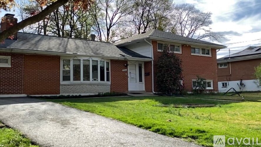 A house with a brick exterior and a white door is for sale.