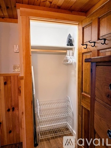 A kitchen with wooden cabinets and a white door.