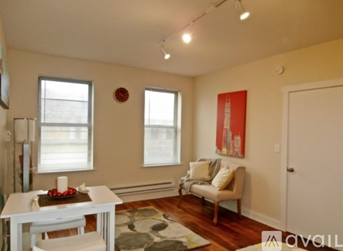A living room with a white table and a couch.