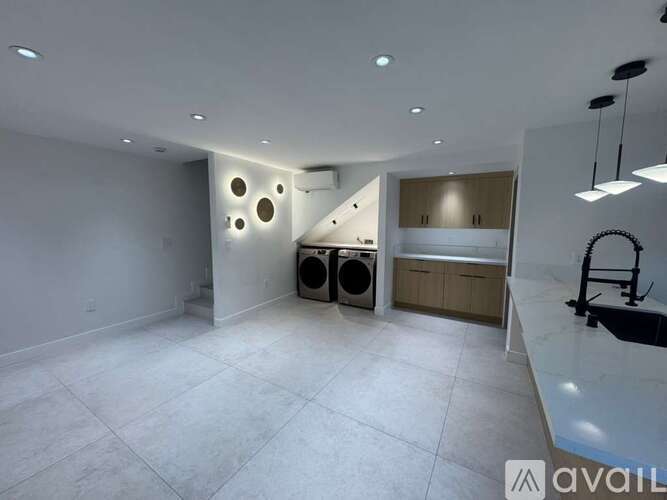 A spacious room with a washer and dryer in it.