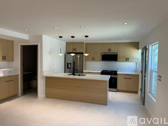 A kitchen with wooden cabinets and a central island.