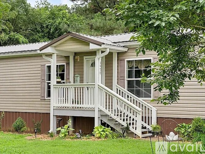 A house with a porch and a front yard.