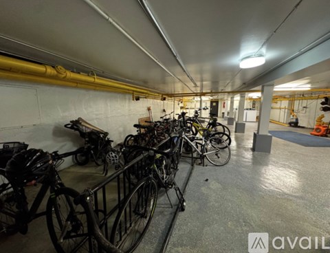 A bike rack with several bicycles parked inside a building.