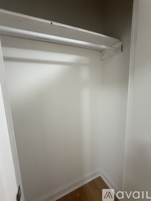 A white closet with a shelf above the door.