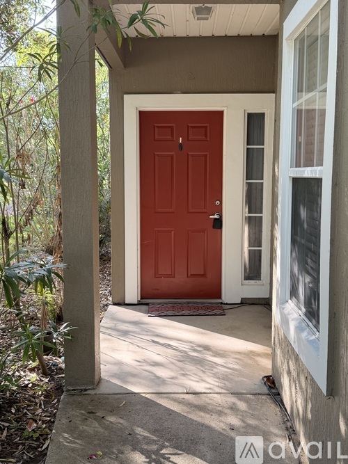 A red door is on the left side of a white door.