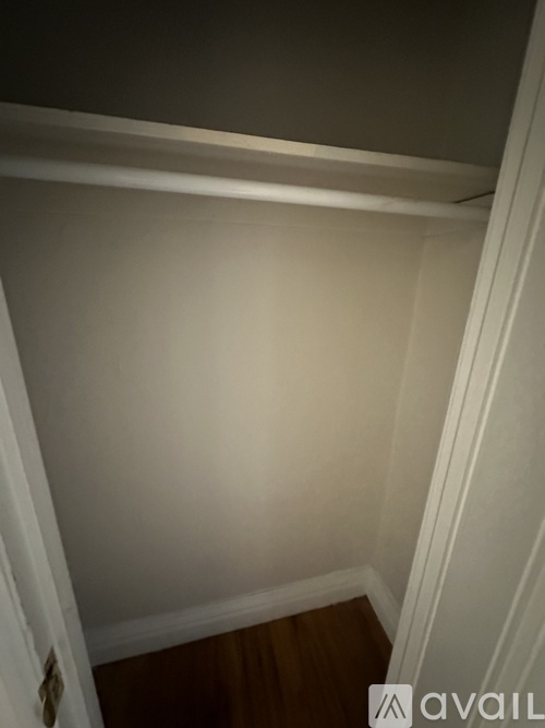 A white wall with a wooden staircase.