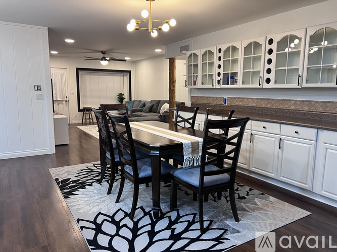 A dining room with a table set for four.