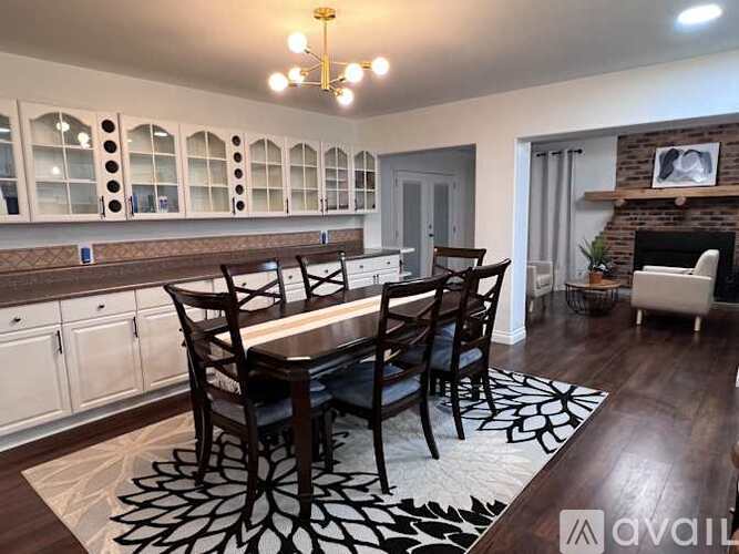 A dining room with a table set for six.